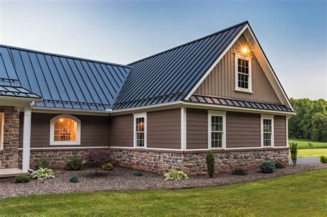 dark brick house with metal roof|matching brick and roof colors.